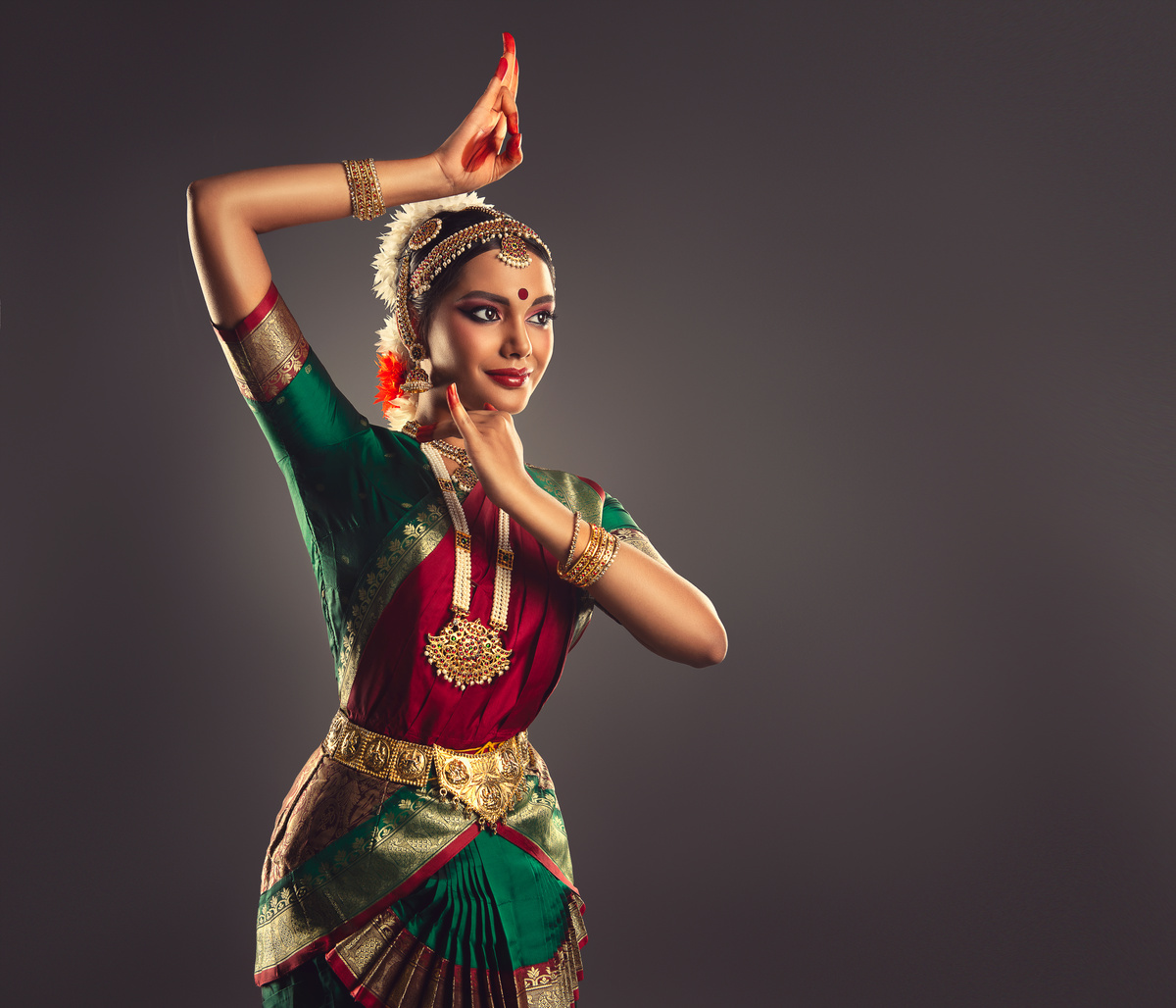 Beautiful woman dressed in a traditional Indian dance suit is shows beauty of classic dance. Indian culture.